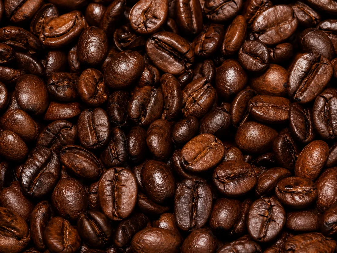 Glossy dark-roasted Colombian coffee beans